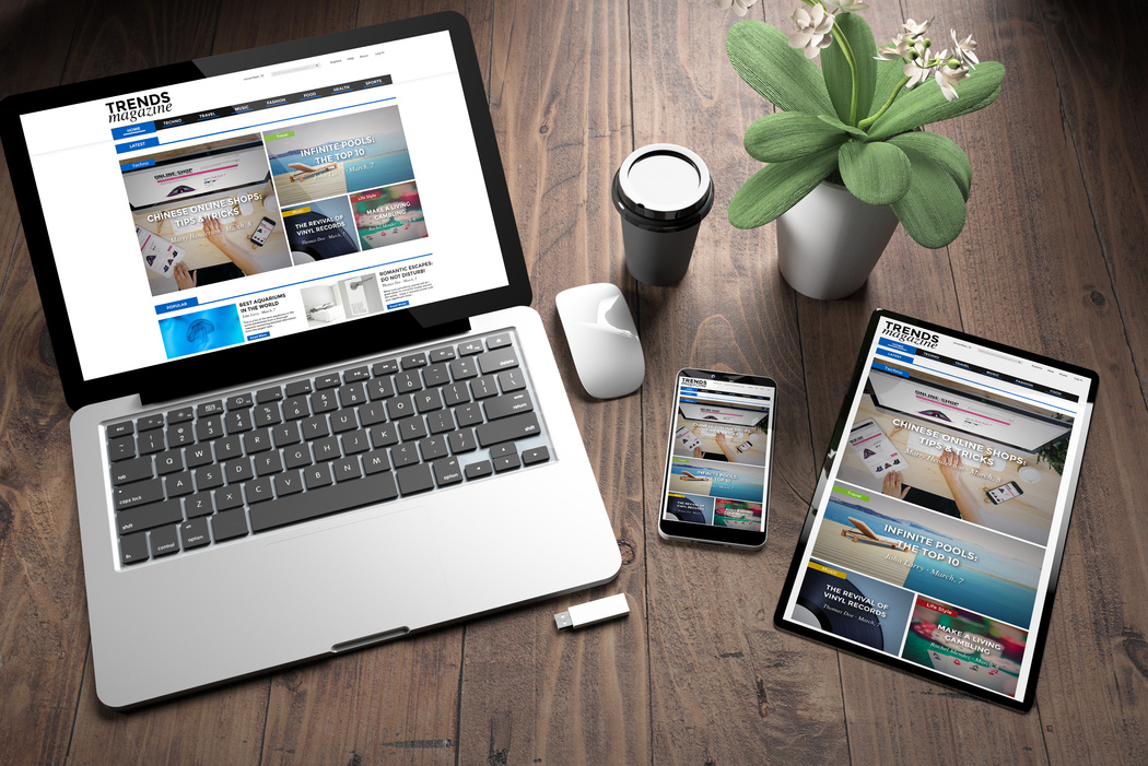 three devices on wooden desk top view e-magazine